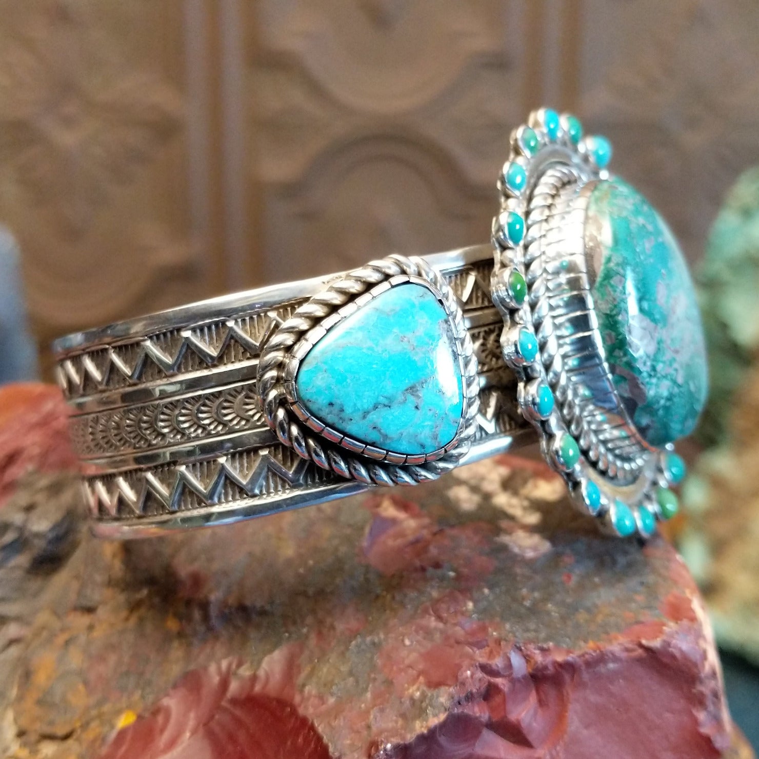 Large sterling silver cuff bracelet with Royston turquoise set in large bezels, framed by stamping and twisted rope designs.