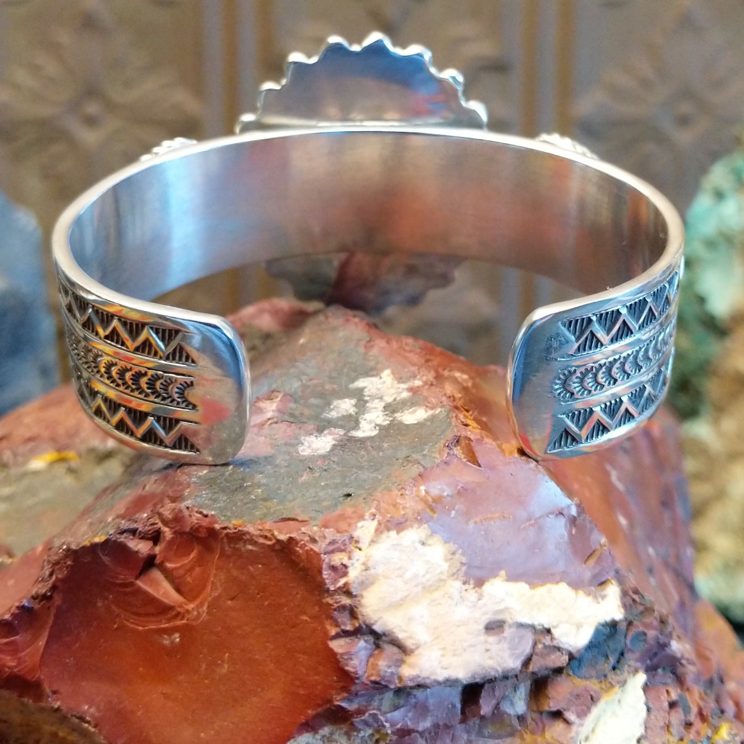 Large sterling silver cuff bracelet with Royston turquoise set in large bezels, framed by stamping and twisted rope designs.