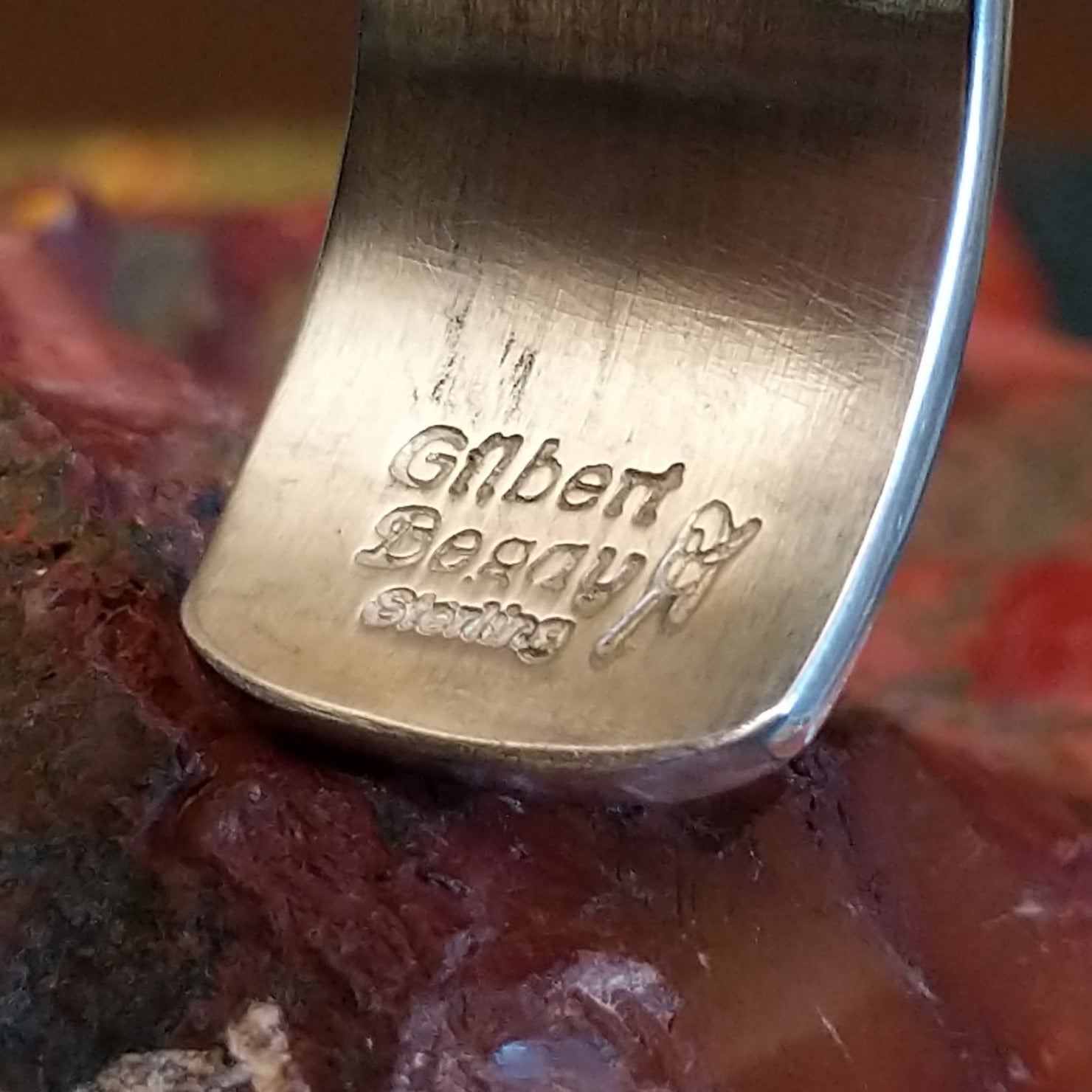 Close-up of the artisan's stamped signature.