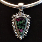 Ruby zoisite set in sterling silver bezels framed by dotted accents on both the earrings and pendant.