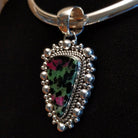 Ruby zoisite set in sterling silver bezels framed by dotted accents on both the earrings and pendant.