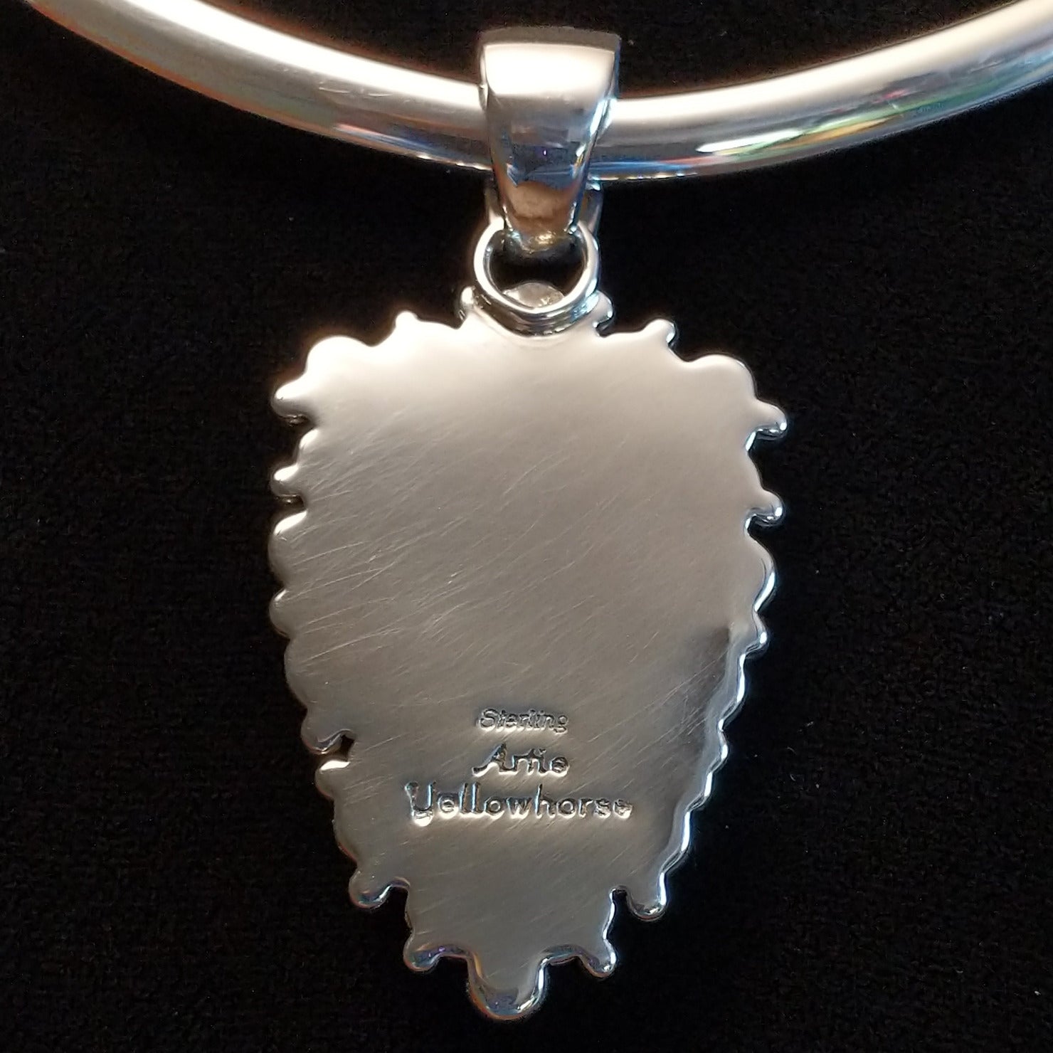 The back features the artisan's stamped signature.