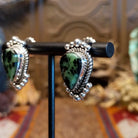 Ruby zoisite set in sterling silver bezels framed by dotted accents on both the earrings and pendant.