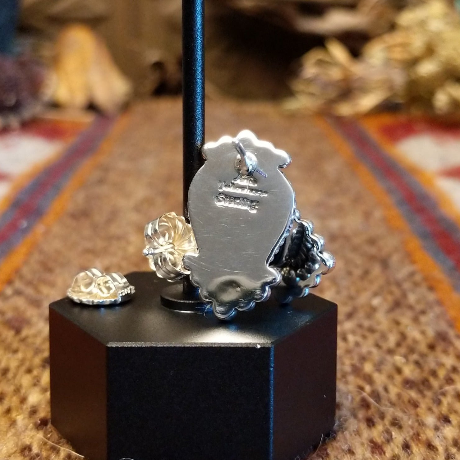 The backings feature the artisan's stamped signature.