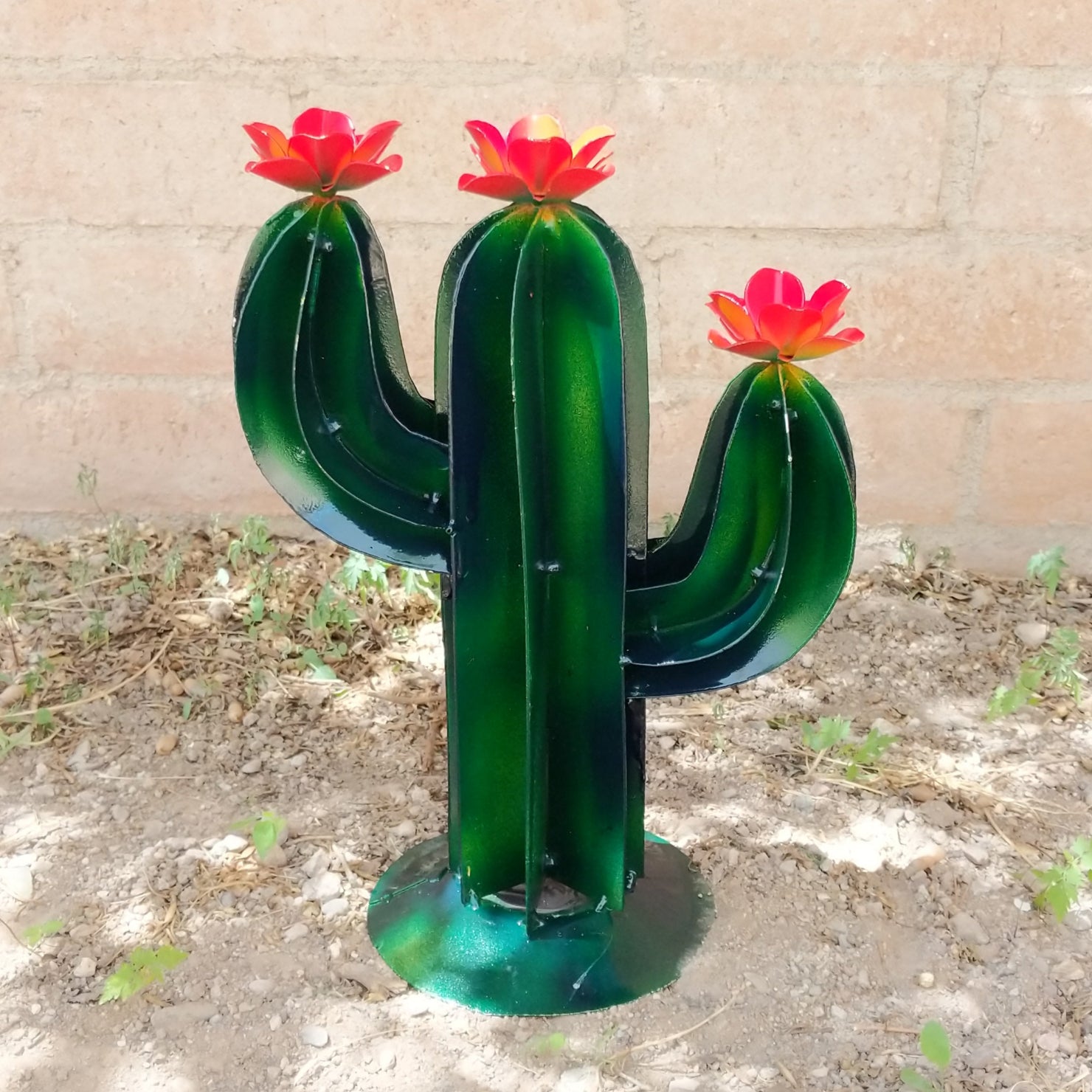 Mini saguaro metal art piece featuring a vibrant green cactus with yellow streaks and red flowers.