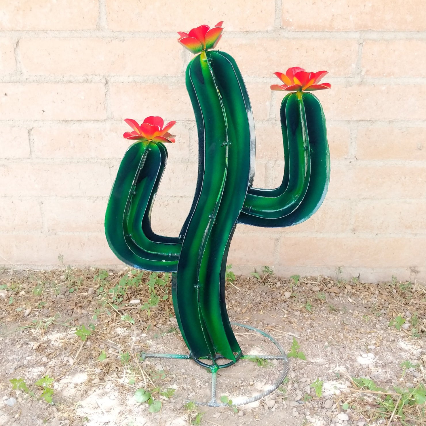 Small saguaro metal art piece featuring a vibrant green cactus with yellow streaks and red flowers.