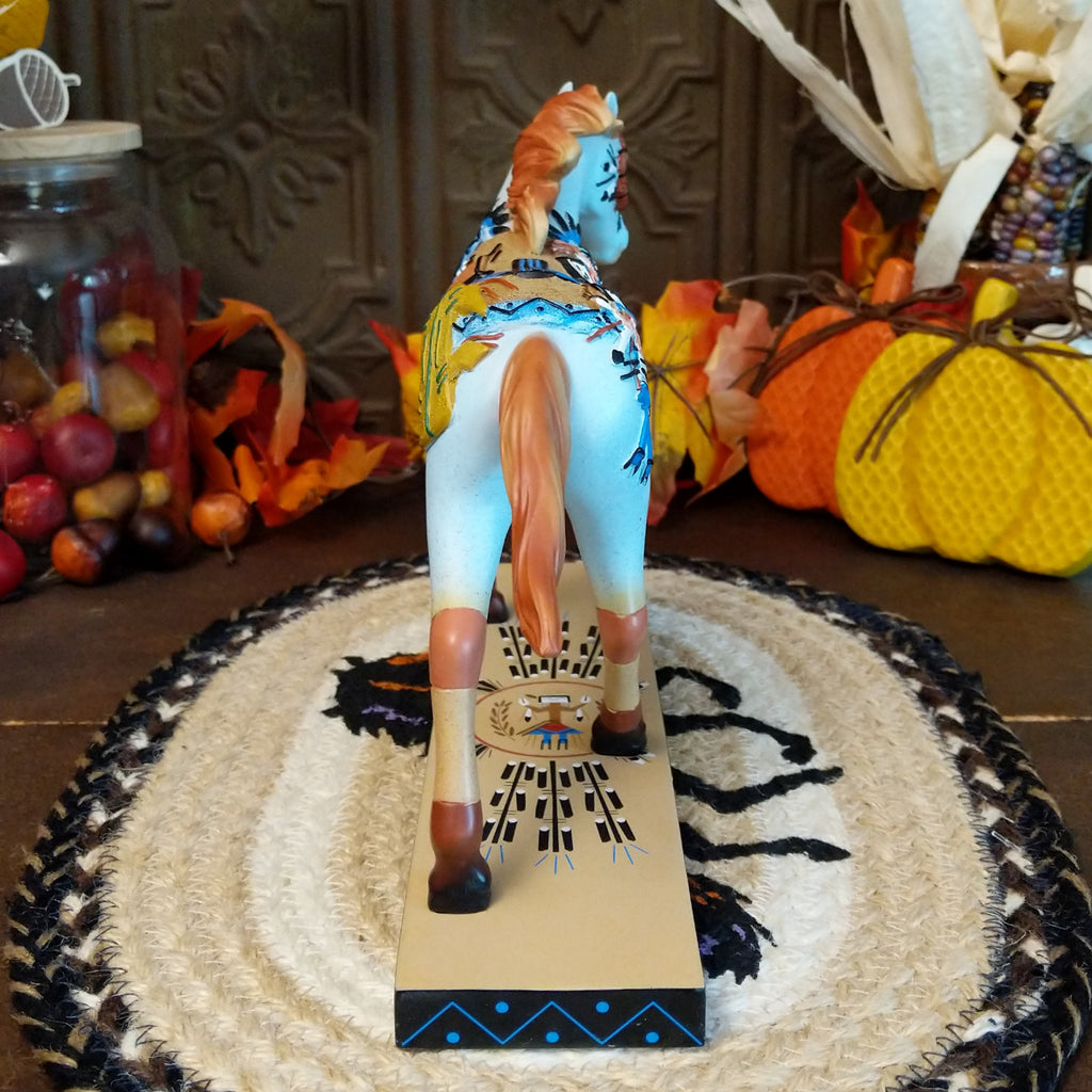 Resin pony painted light blue with orange accents featuring Native American sand painting motifs along the body.