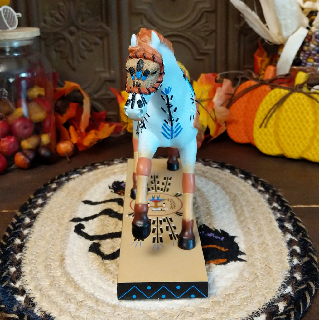 Resin pony painted light blue with orange accents featuring Native American sand painting motifs along the body.