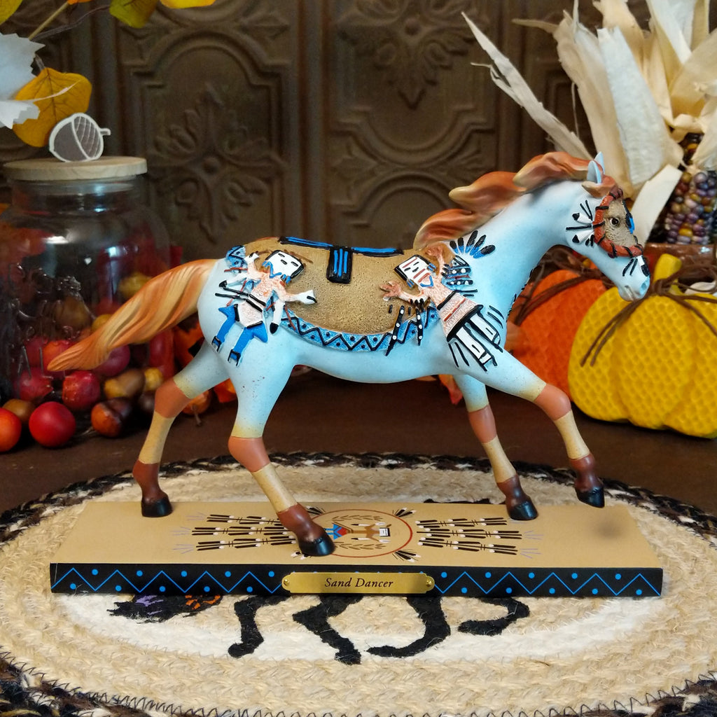 Resin pony painted light blue with orange accents featuring Native American sand painting motifs along the body.