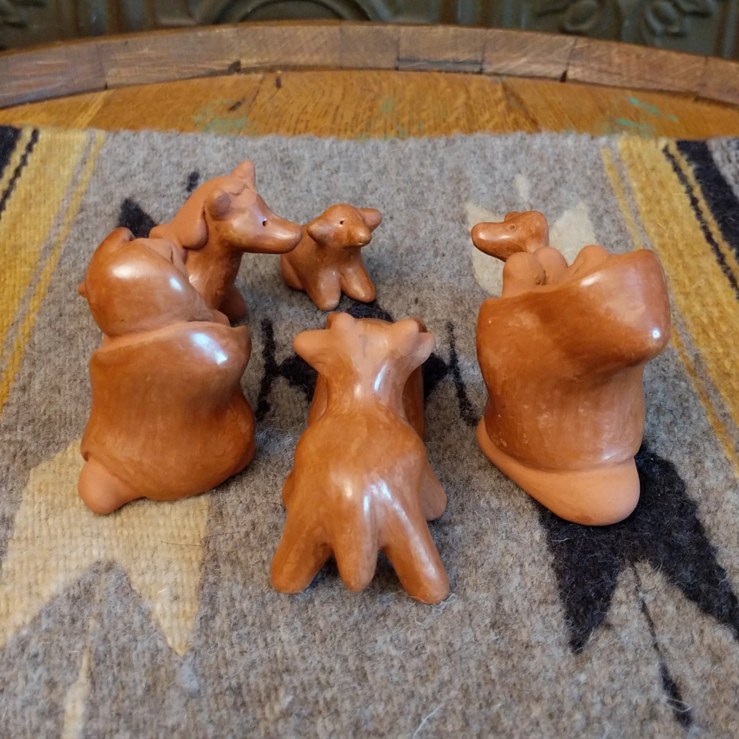 Clay sculpted into individual pieces of a nativity scene and glazed.