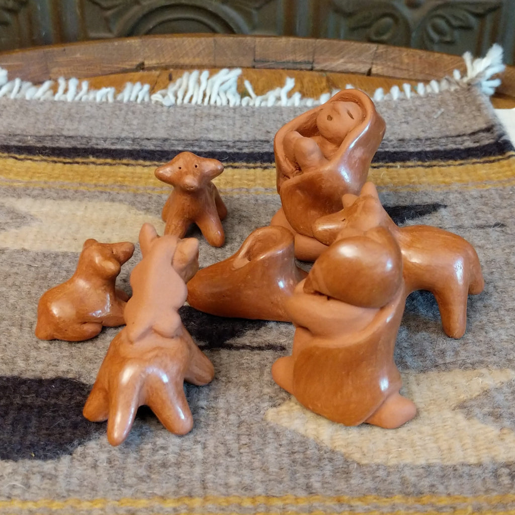Clay sculpted into individual pieces of a nativity scene and glazed.