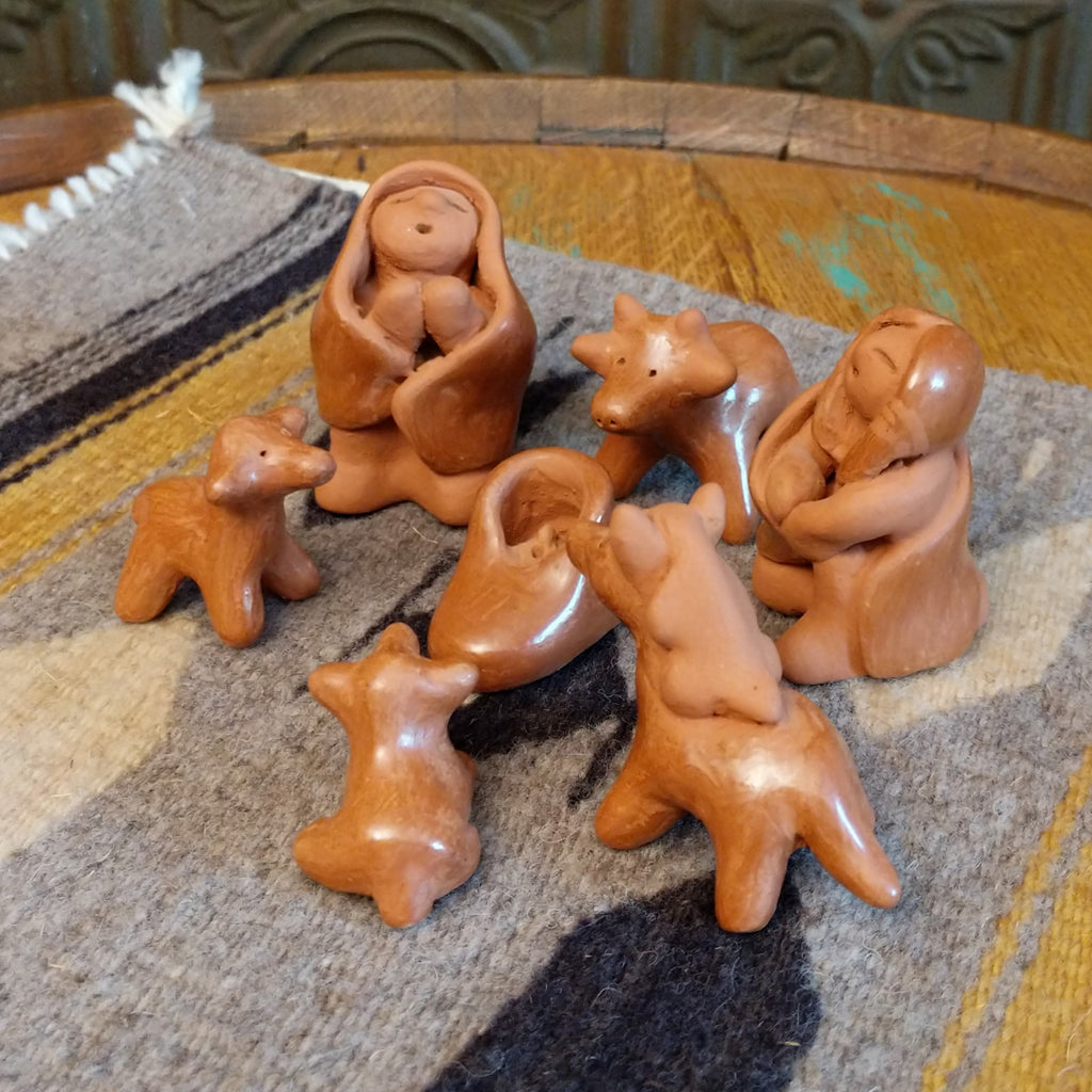 Clay sculpted into individual pieces of a nativity scene and glazed.