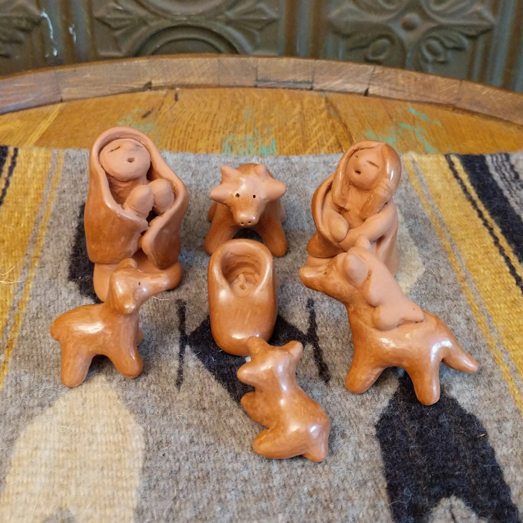 Clay sculpted into individual pieces of a nativity scene and glazed.
