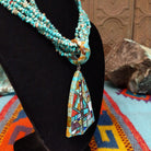 Multi-strand turquoise bead necklace with a large geometric multistone mosaic pendant