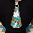 Sterling silver necklace with turquoise and white buffalo beaded along the chain and inlaid on the pendant.
