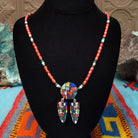 Red-orange bead necklace with a round multistone mosaic centerpiece and two matching dangling mosaic pendants