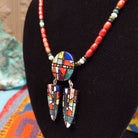 Red-orange bead necklace with a round multistone mosaic centerpiece and two matching dangling mosaic pendants