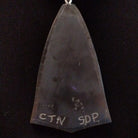 Close-up of the artisan's stamped signature.