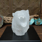 A frosted Lucite sculpture of a roaring grizzly bear with two hand-painted grizzly bears facing off inside the clear crystal interior.