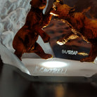A frosted Lucite sculpture of a roaring grizzly bear with two hand-painted grizzly bears facing off inside the clear crystal interior; artisan signature and production number.