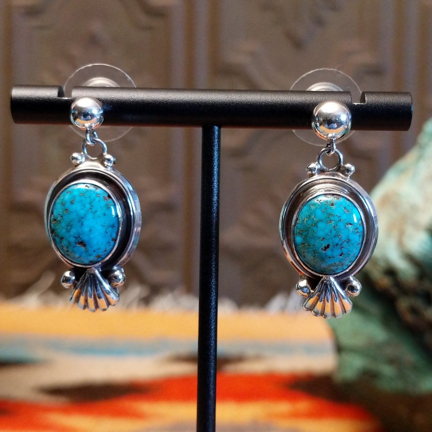 Sterling silver earrings with Kingman turquoise set in the raised bezels, framed by the scalloped design.