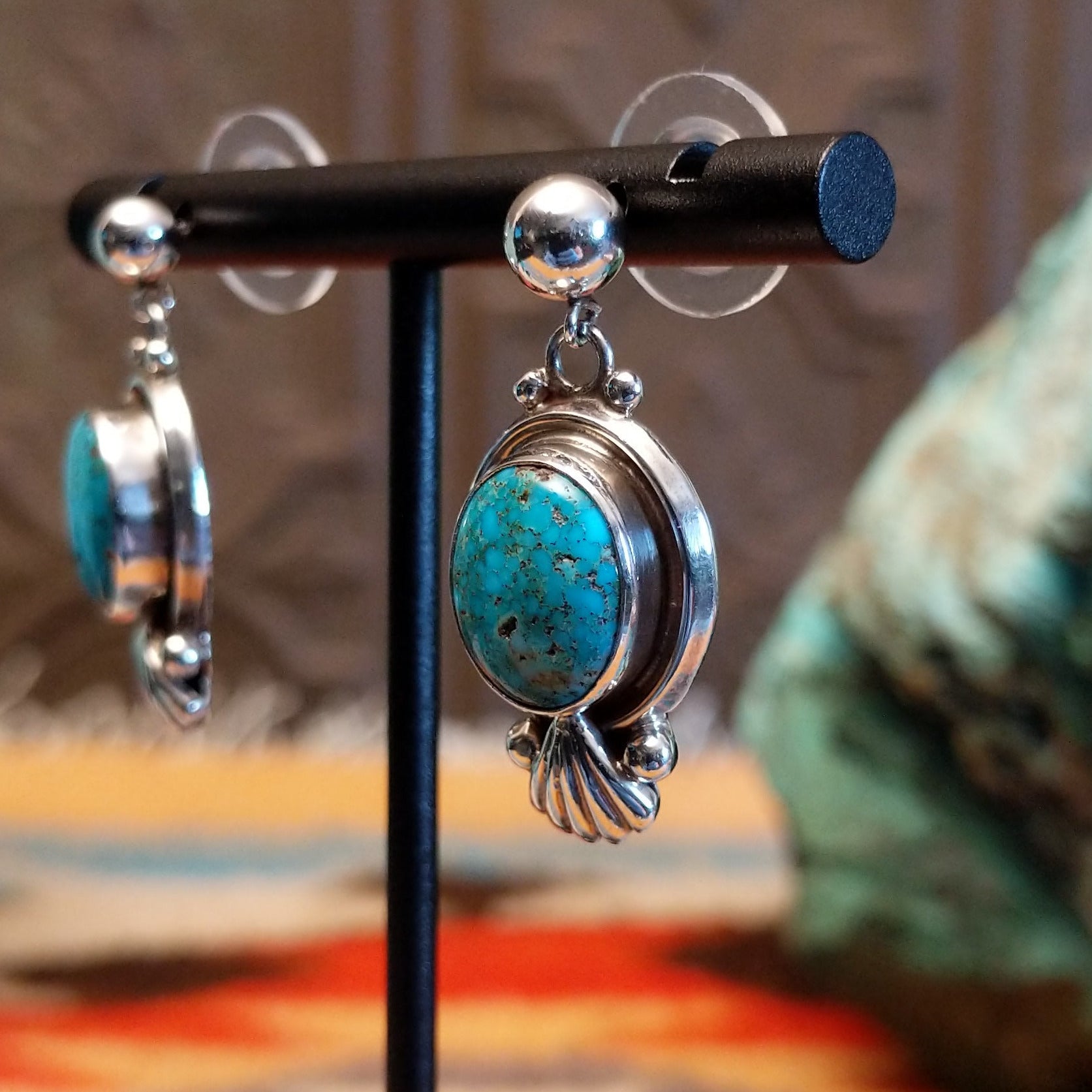 Sterling silver earrings with Kingman turquoise set in the raised bezels, framed by the scalloped design.