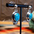 Sterling silver earrings with Kingman turquoise set in the raised bezels, framed by the scalloped design.