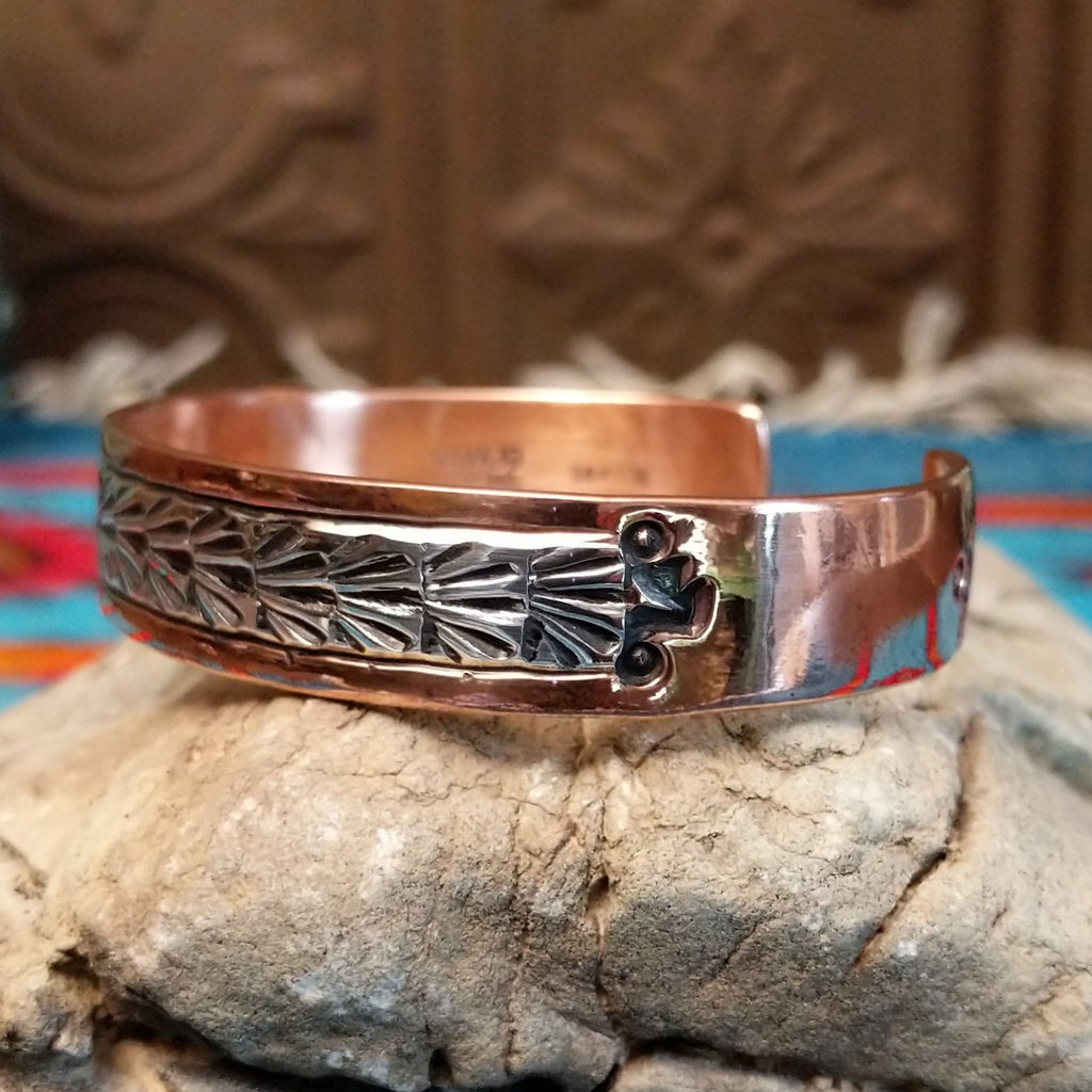 Copper and sterling silver cuff with stamped shrub design on the silver.