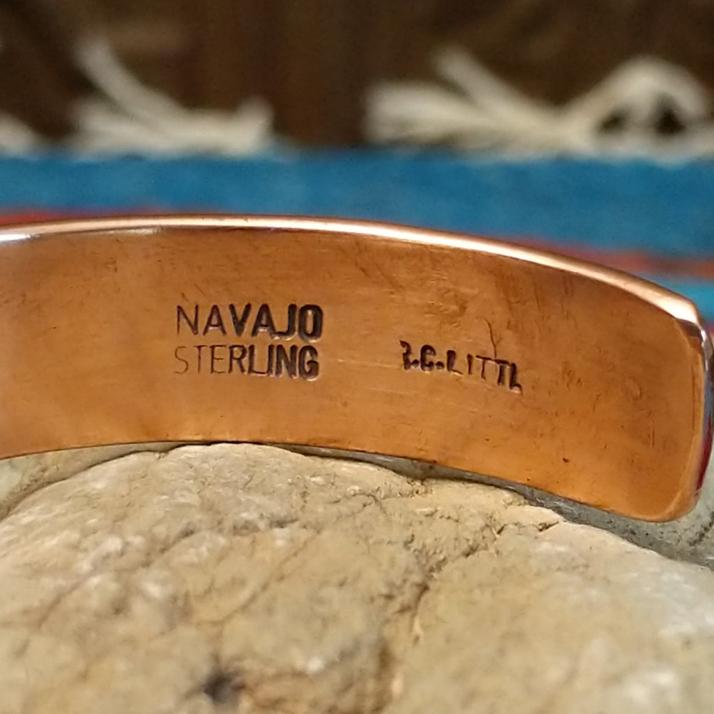 Close-up of the artisan's stamped signature.