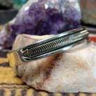 Sterling silver and 14k gold cuff by Bruce Morgan with curved stamped center design.