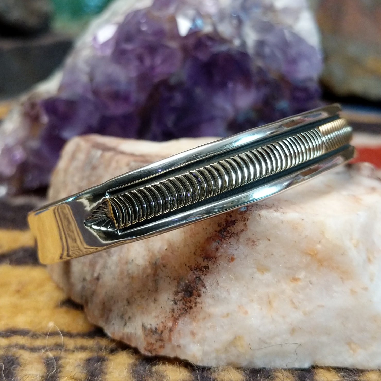 Sterling silver and 14k gold cuff by Bruce Morgan with curved stamped center design.