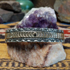 Sterling silver and 14k gold cuff by Marc Antia with sunbeam stampwork and floral accents.