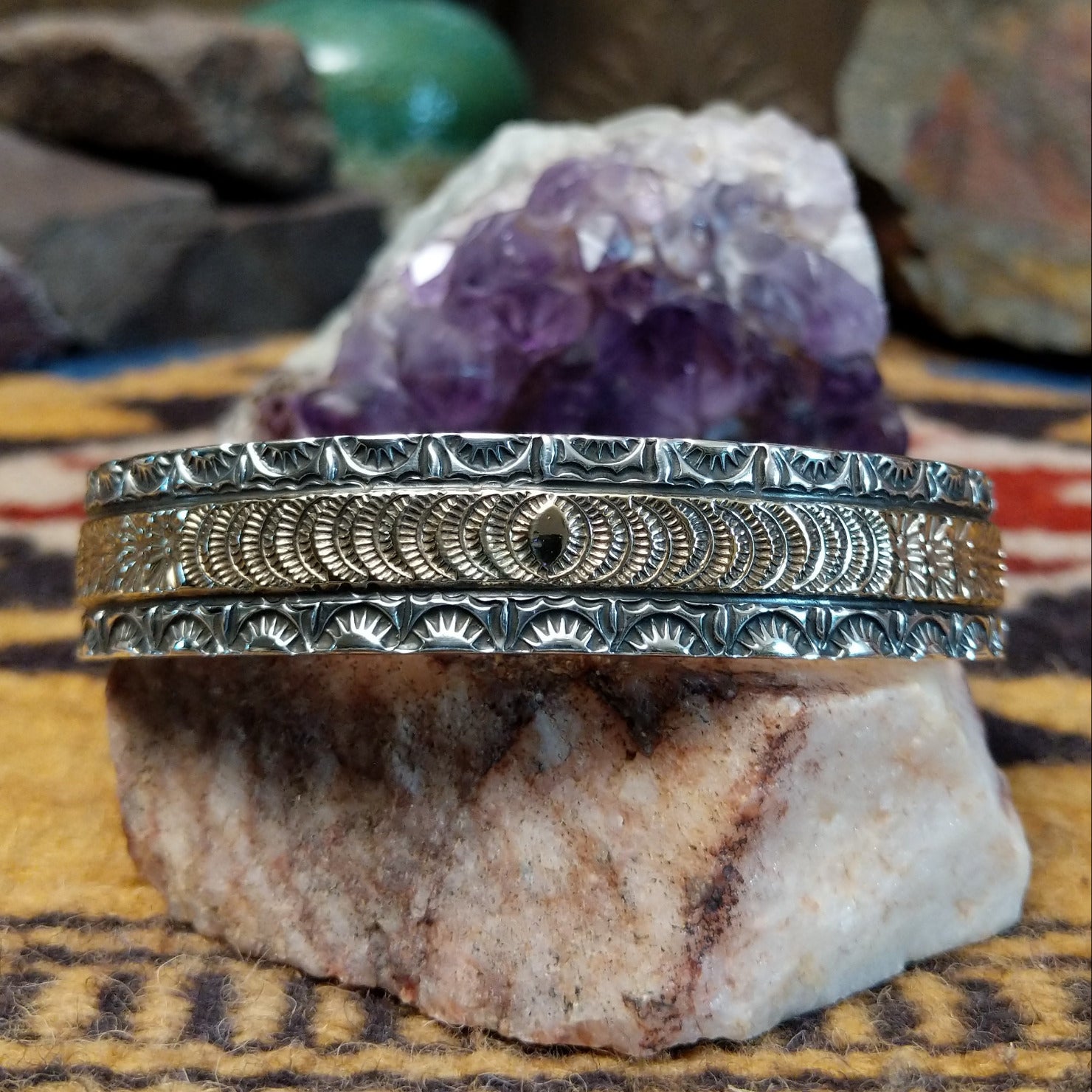 Sterling silver and 14k gold cuff by Marc Antia with sunbeam stampwork and floral accents.