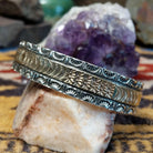 Sterling silver and 14k gold cuff by Marc Antia with sunbeam stampwork and floral accents.