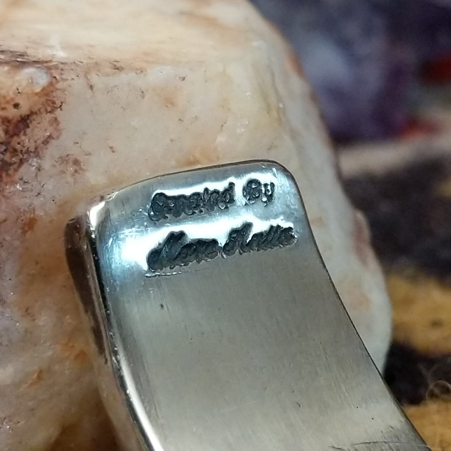 Close up of the artist's stamped signature.
