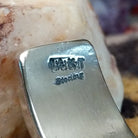 Close up of stamped 14KT and Sterling, indicating 14 karat gold and sterling silver construction.