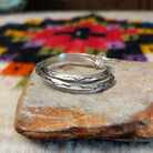Silver angular hoop earrings by Verna Tahe.