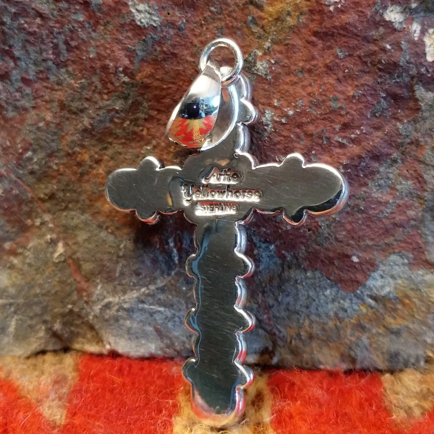 Sterling silver beaded cross pendant by Navajo artisan Artie Yellowhorse, showing artisan hallmark