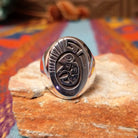 Silver Bison Ring by Calvin Peterson featuring a raised bison motif with geometric detailing, darkened recessed accents, and a polished Sterling Silver oval face and band.