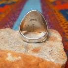 Silver Bison Ring by Calvin Peterson featuring a raised bison motif with geometric detailing, darkened recessed accents, and a polished Sterling Silver oval face and band; underside view.