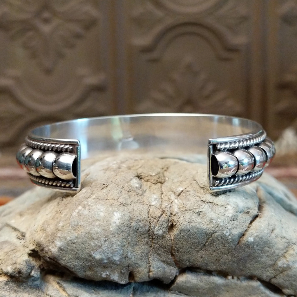 Sterling silver cuff with bubble texture and twisted rope accents.