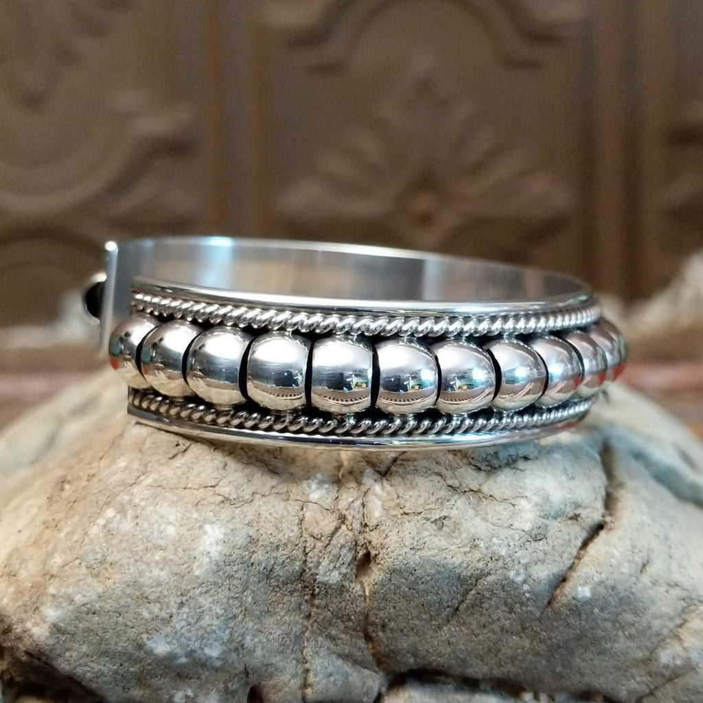 Sterling silver cuff with bubble texture and twisted rope accents.