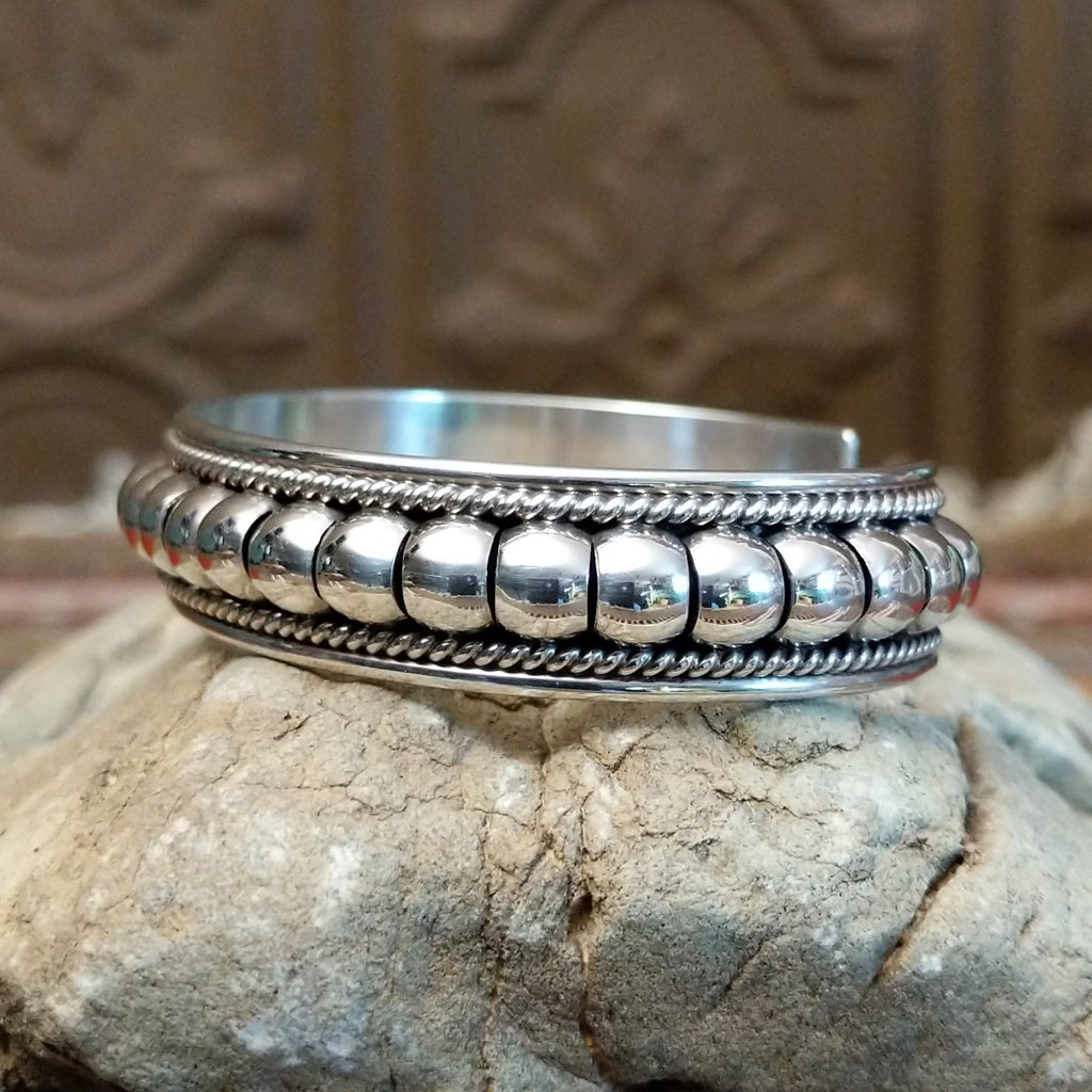 Sterling silver cuff with bubble texture and twisted rope accents.