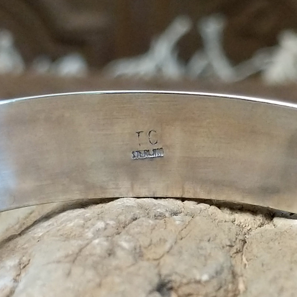 Close-up of the artisan's initials on the interior.