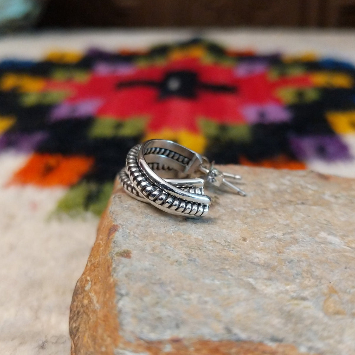 Silver coil hoop earrings by Katrina Tsosie.
