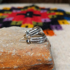Silver coil hoop earrings by Katrina Tsosie.