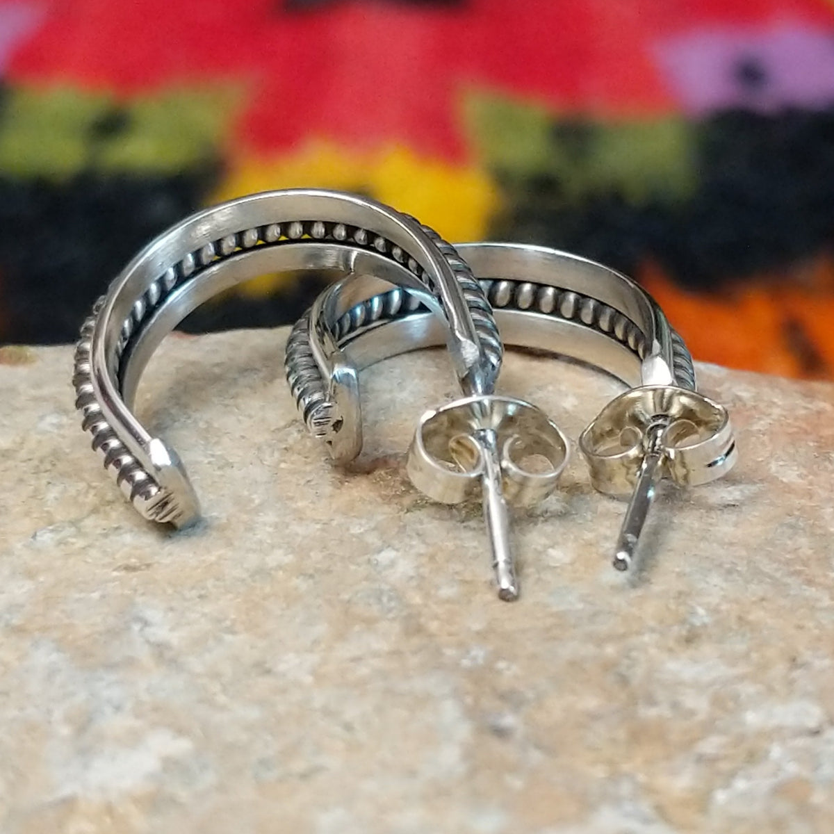 Silver coil hoop earrings by Katrina Tsosie.