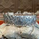 Sterling silver cuff with stamped diamond designs and polished finish.
