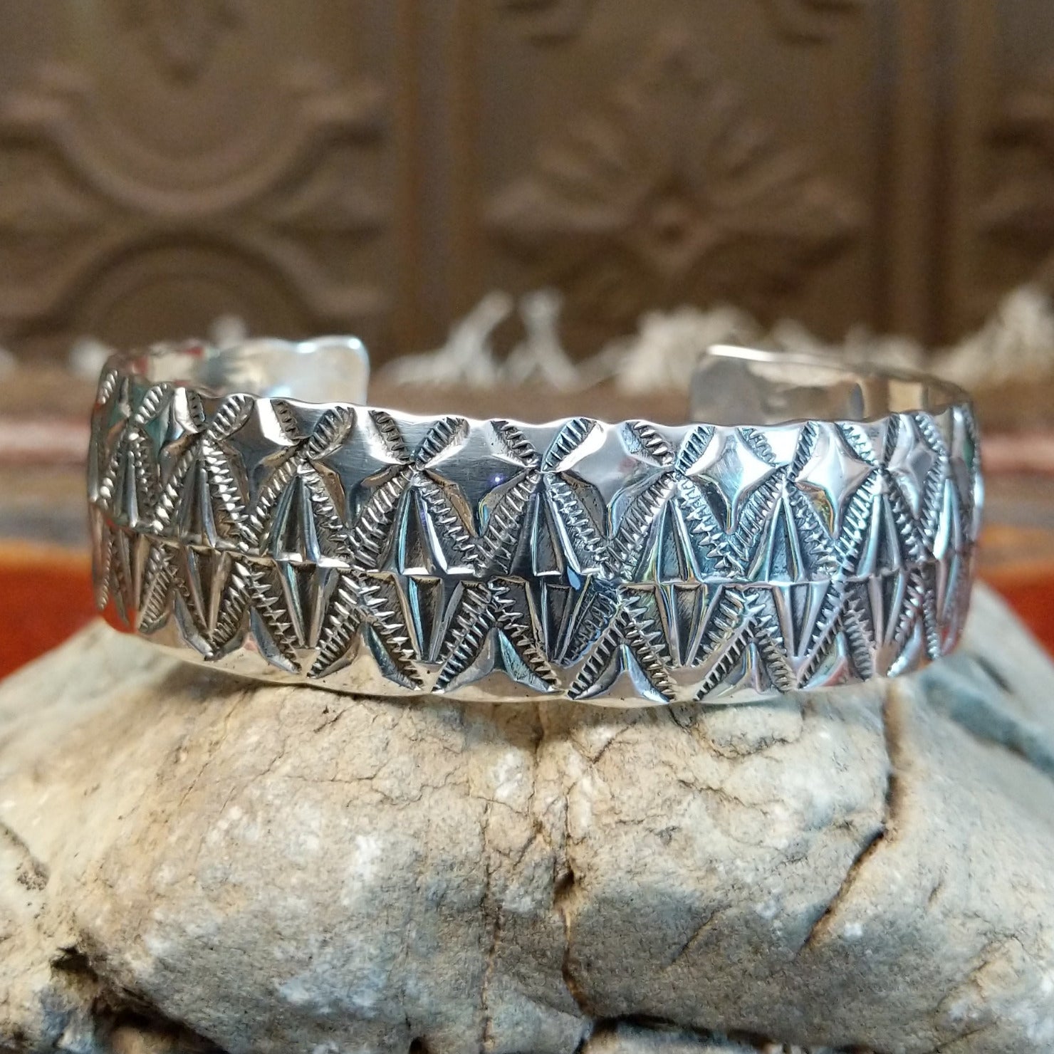 Sterling silver cuff with stamped diamond designs and polished finish.