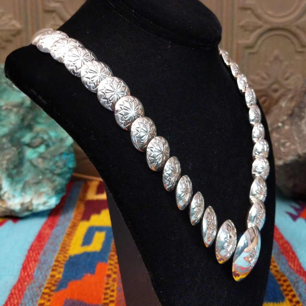 Silver Disc Necklace by Carol Smith with graduated domed discs and repeating stamped floral designs.